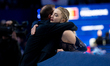 Amber Glenn and coach Damon Allen are seen during the women's free skating at the ISU Figu...
