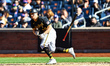 Pittsburgh Pirates player Jake Mangum #28 bunts during the ninth inning of a baseball game...