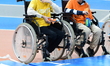 Schoolchildren in wheelchairs participate in a sports session for the launch of the 2026 O...