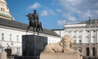 A stone lion and the Prince Jozef Poniatowski monument are seen in front of the Presidenti...
