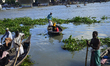 Bangladeshi boats man paddles his row boat with passengers on the Buriganga River in Dhaka...