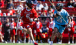 Kasey Mongillo of the Rutgers Scarlet Knights drives the ball against Charlie Hazard of th...