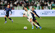 Bensebaini Rami Amir of Algeria and Canobbio Graviz Agustin of Uruguay in action during a...