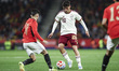 Pedri of Spain controls the ball while being defended by Marwan Attia of Egypt during the...
