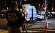 Members of the NYPD Crime Scene Unit collect a blood-stained hat on Humboldt Street after...