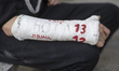 A young man with a cast on his arm bearing a ''1312'' inscription, symbolizing a protest a...