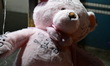 A vigil with teddy bears, flowers, and candles is held one day after a 7-month-old girl, i...