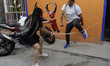 Participants in the Judas Procession in Mexico City, Mexico, wear devil masks in observanc...