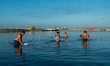 Flagellants with bloodied backs wash their wounds in the waters of Manila Bay after perfor...