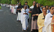 Christian devotees hold a cross during a Good Friday procession in Kochi, India, on April...