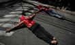 Hooded penitents lie prostrate on the ground in Mandaluyong City, Philippines, on Maundy T...