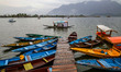 A man rows a boat on the waters of Dal Lake during rainfall in Srinagar, Jammu and Kashmir...