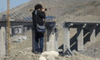 An Iranian press photographer takes photographs of the B1 bridge in the city of Karaj, sev...