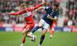Tristan Crama of Millwall FC takes the ball away from Tommy Conway of Middlesbrough FC dur...