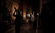 Penitents from a local religious confraternity known as confratelli walk in the street as...