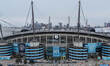 An aerial view of The Etihad Stadium and the city of Manchester high-rise buildings in the...