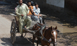 Residents commute via a horse-drawn cart, known locally as a tanga, in Lahore, Pakistan, o...