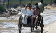 Residents commute via a horse-drawn cart, known locally as a tanga, in Lahore, Pakistan, o...