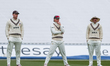 Jamie Smith, Ollie Pope, and Rory Burns of Surrey wait for the next delivery during the Ro...