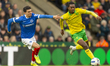 Paris Maghoma of Norwich City and Andre Dozzell of Portsmouth compete for the ball during...