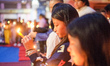 Catholic faithful hold candles during an Easter Vigil procession at a church as part of Ea...
