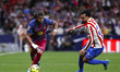 Lamine Yamal of FC Barcelona and Nico Gonzalez of Atletico de Madrid in action during the...