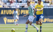 Dani Requena of Cordoba CF competes for the ball with Joaquin Gonzalez of Cadiz CF during...