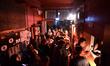 People queue at the entrance after the reopening of the Turbina nightclub at midnight in B...