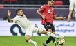 Jassem Gaber (R) of Al Rayyan SC and Paulo Silva (L) of Al Sadd SC compete during the Qata...