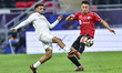 Rodrigo Machado (R) of Al Rayyan SC and Hashim Ali (L) of Al Sadd SC compete during the Qa...