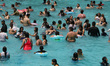People enjoy the Pantitlan Olympic Swimming area in the eastern zone of Mexico City, cooli...
