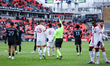Referee Ricardo Monteiro Araya issues a red card to a Toronto FC player after reviewing th...