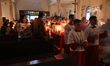 Palestinian Christians attend the 'Holy Fire' procession at the Church of the Holy Family...