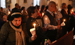 Palestinian Christians attend the 'Holy Fire' procession at the Church of the Holy Family...