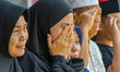 Family members of Infantry Major (Anm) Zulmi Aditya Iskandar weep during a funeral ceremon...
