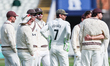 Surrey players celebrate taking the wicket of Ed Barnard of Warwickshire, bowled by Matthe...