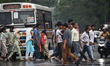 People cross the road after heavy rain in Kolkata, India, on April 5, 2026. 