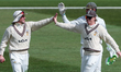 Rory Burns of Surrey (left) is congratulated for the catch that dismisses Dan Mousley of W...