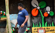 A person walks past a symbol of the Trinamool Congress ahead of the assembly election in K...