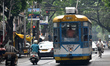 A tram car drives past a busy crossing in Kolkata, India, on April 5, 2026. 