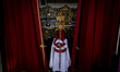 Penitents of the Cofradía 15+1 march through the streets of L’Hospitalet de Llobregat, a c...