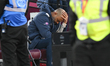 Nuno Espirito Santo, manager of West Ham United, holds his head while sitting on the bench...