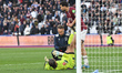 Max Kilman of West Ham United assists goalkeeper Alphonse Areola with the medical team dur...