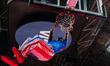 A Harlem Globetrotters showman performs a dunk with the Visa logo visible in the backgroun...