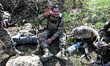 A recruit waves a hand while sitting on the ground during a break on Day Zero of Basic Mil...