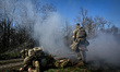 Recruits, supervised by instructors, lie on the ground during a march on Day Zero of Basic...