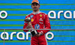 Scuderia Ferrari HP driver #16 Charles Leclerc (MON) holds the third-place trophy on the p...