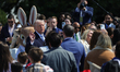 U.S. President Donald Trump speaks to guests during the 2026 White House Easter Egg Roll o...