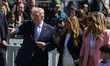U.S. President Donald Trump and First Lady Melania Trump watch children run during the 202...