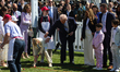U.S. President Donald Trump helps a child during the 2026 White House Easter Egg Roll on t...